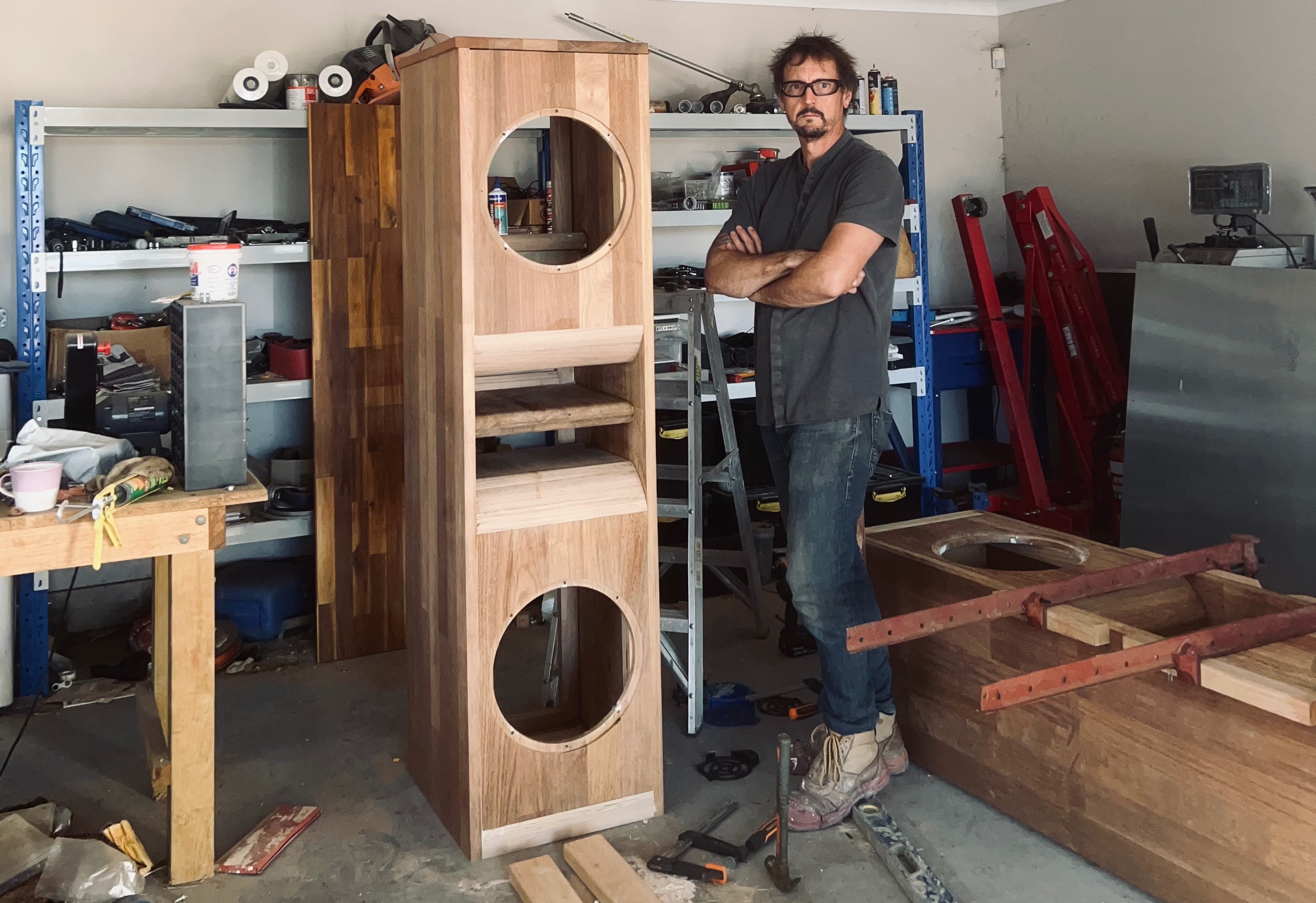 Workshop construction of custom wooden speaker cabinets showing engineering and craftsmanship process