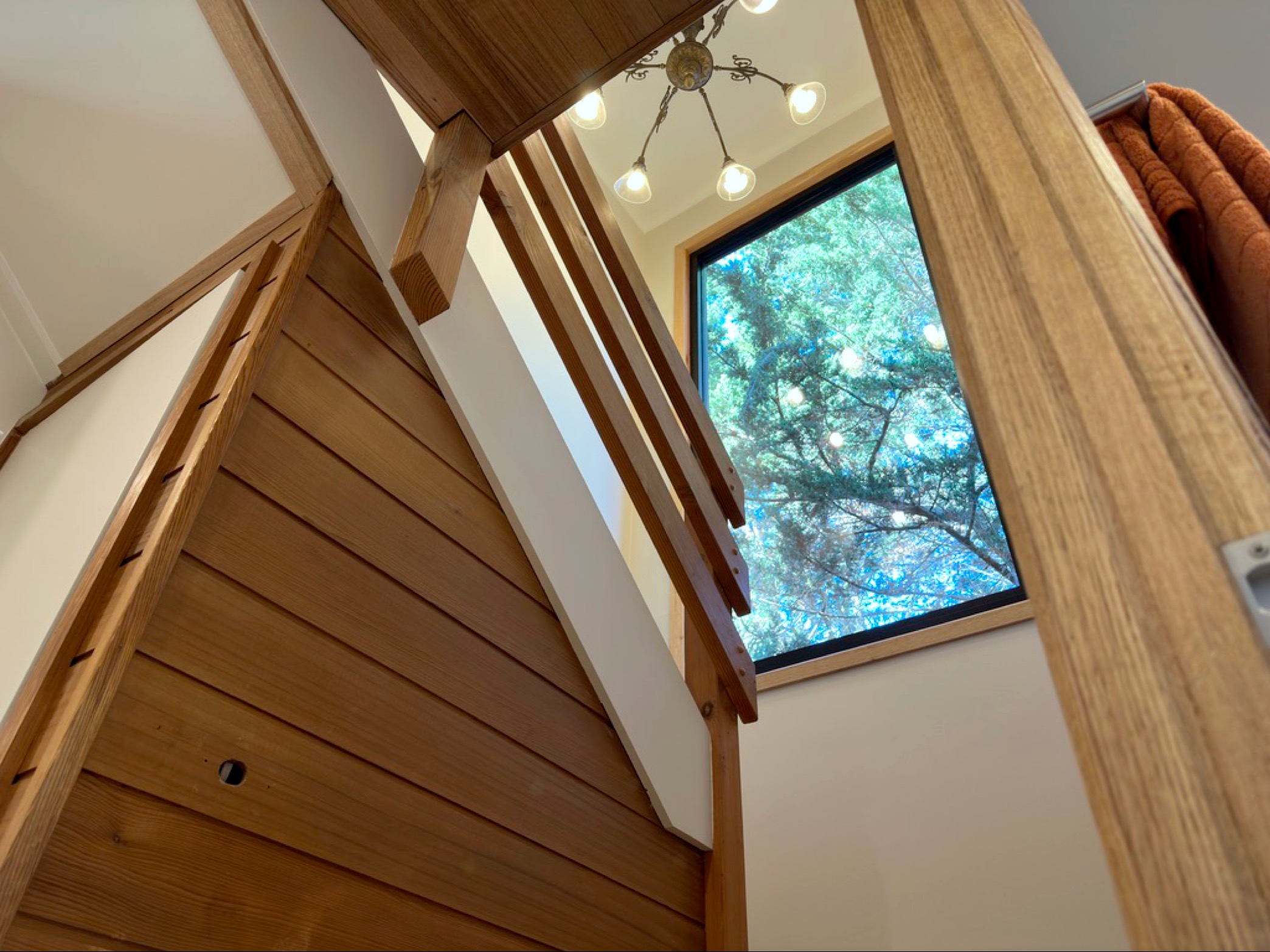 Wooden beam construction with modern lighting and window