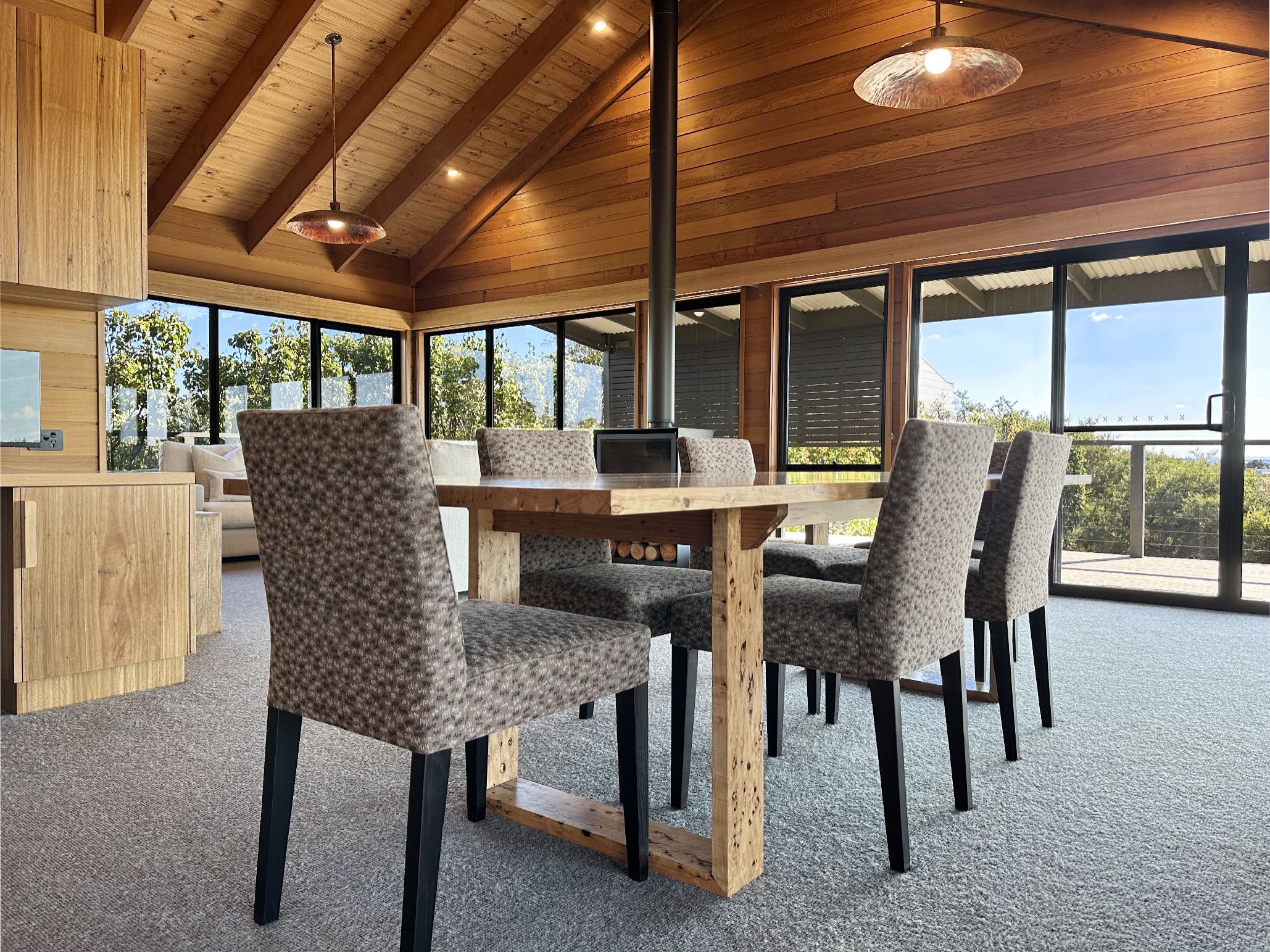 Modern dining area with wooden beams and large windows